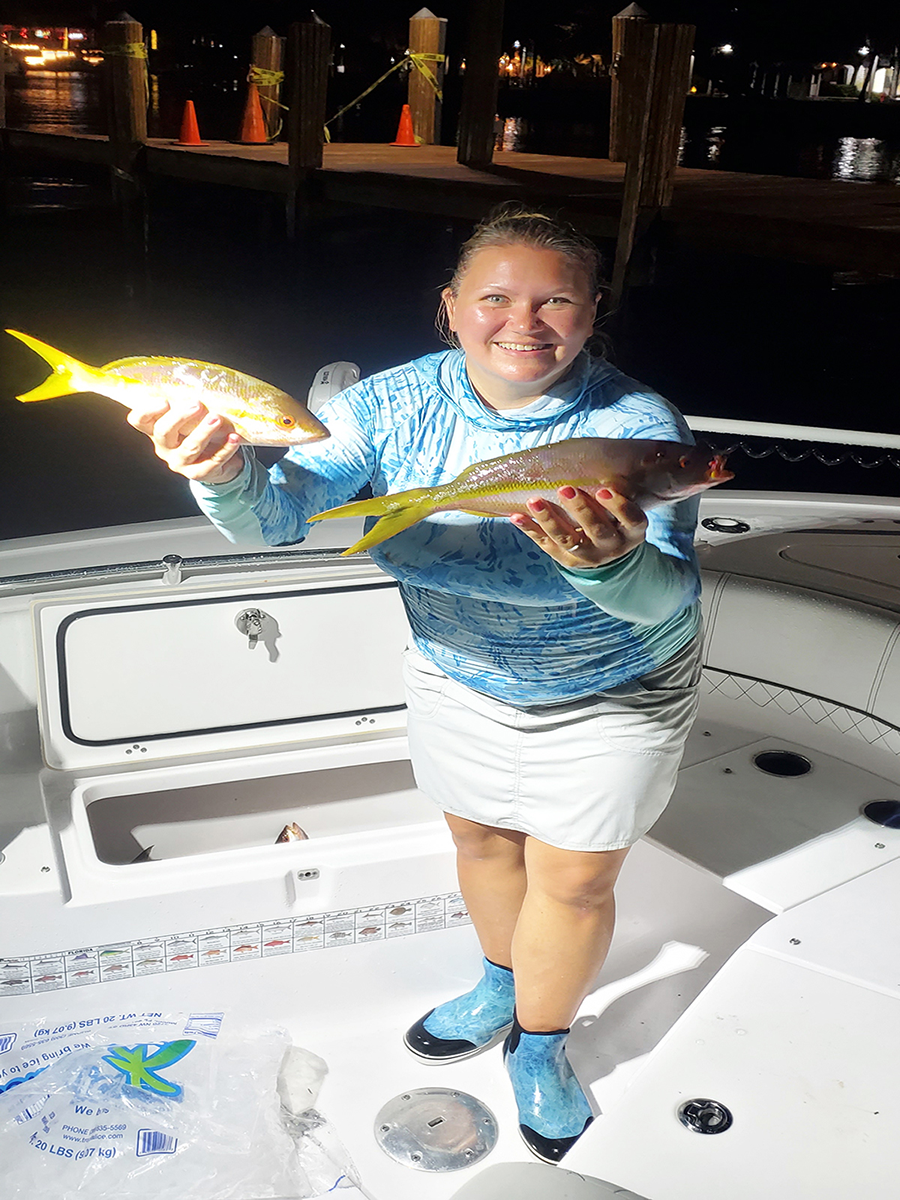 an image of katie holding two nice reef caught yellowtail snappers