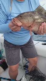 a video of katie koch releasing a tagged red grouper wearing her offshore perf shirt
